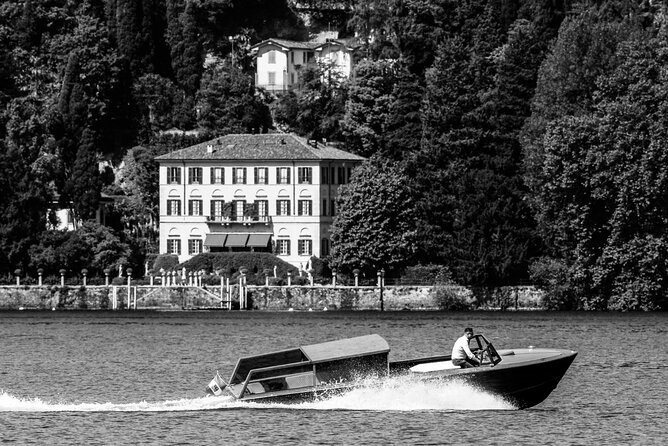 4 Hours Private Wooden Boat Tour stop Bellagio Varenna 6 pax - Leaving Como beside modern art and seaplanes