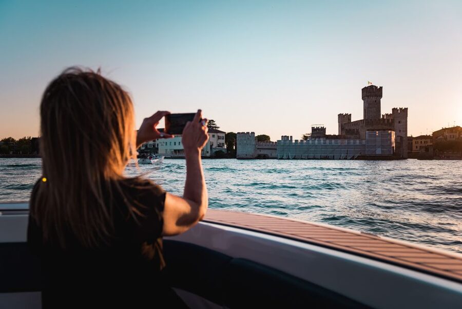 Desenzano del Garda: Sunset Boat Trip at Sunset with Drink - The sunset view of Sirmione’s castle