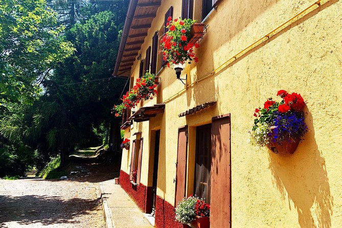 MTB Tour Lake Como Mountain Views & Local Cuisine - Faro Voltiano adds a landmark and an Alpine view